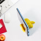 Mobile stand shaped like an apple displaying pens and phone in upright position