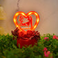 Decorative couple statue in heart-shaped frame with rose base