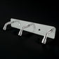Stainless steel coat hook rack holding towels and bags