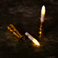 Close-up of a flameless LED candle light showing its realistic flicker and elegant gold base.