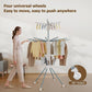 Clothes drying rack in use with multiple hanging garments drying