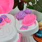 Assortment of vibrant pretend makeup accessories from the toy set.