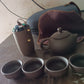 Tea set with teapot, cups & accessories on a wooden tray for travel or home