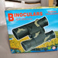 A child looking through Learning Toy Binoculars, engaging with nature.