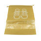 Compact folded waterproof shoe bag next to a pair of shoes, highlighting its portability.
