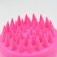Scalp cleansing brush with ergonomic handle for deep hair wash.