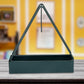 Stylish triangular mosquito coil holder hanging on a rustic wooden wall.