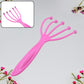 The portable scalp massager placed beside a soft pillow, ready for a relaxing session.