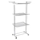 The 3-tier stainless steel drying rack with wheels, fully loaded with laundry.