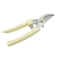 Pruning shears effortlessly cutting a small branch in a garden.