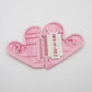 Heart-shaped safety trimming scissors on a clean surface