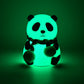 Side view of the charming panda night light, showcasing its smooth silicone texture.