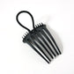 Hair styling comb clip securing hair in a voluminous bun style