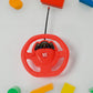 A child's hand guiding the rechargeable RC car across a smooth surface, in action.