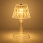 A detailed view of the acrylic crystal table lamp on a wooden surface.