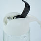 Pouring olive oil using glass oil bottle dispenser in kitchen setting