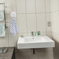 Strong plastic suction cup hook supporting towel on bathroom wall