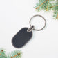 Elegant oval keychain accessory in black and silver tones