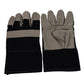 Pair of robust gardening gloves lying on garden soil with tools.