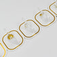 Transparent adhesive hooks installed on a white wall, blending seamlessly with home decor.