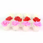 Textured glass holder enhancing the soft glow of rose shaped LED candle
