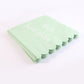 Tissue napkins with scalloped edges and baby party theme text in mint green
