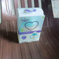 The complete Feedora baby feeding bottle set, including the bottle, straw, handles, and brush.