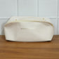 Open travel organizer pouch displaying internal compartments for toiletries
