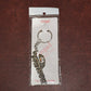 Back side of Jai Dwarkadhish metal keychain showing key ring