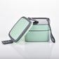 Stackable green lunch box with multiple compartments for varied meals.