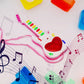 The battery-operated mini guitar toy with a focus on its light-up elements.