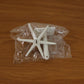Versatile adhesive hook applied to a glass surface, holding various small items.
