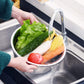 The stainless steel drain basket from the set, effectively straining washed vegetables or fruits.
