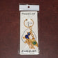 Golden Krishna Peacock keychain packaged in a Peepal Leaf blister pack