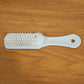 Close-up of ergonomic handle and bristles on handheld cleaning brush