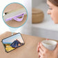 Person comfortably holding a phone with the silicone phone finger holder for enhanced one-handed use.