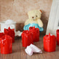 A set of 24 multicolor flameless LED candles with a melted wax design, glowing warmly.