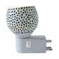 Warm glowing star pattern mosaic glass night lamp creating cozy ambience