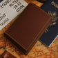 PU leather card holder held in hand showcasing its slim profile and stitching detail
