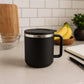 Top-down view of the black insulated coffee mug with its secure silicone lid.