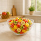 Transparent bowl used for serving snacks and fruits with textured grip