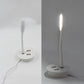 Compact Portable USB Fan and light connected to a power source.