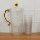 Matching tumblers complementing the textured glass water jug set