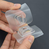 Self-adhesive transparent hook providing a strong hold on a clean wall.
