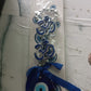 Double OM evil eye hanging displayed indoors enhancing vastu energy