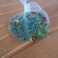 Detailed close-up of glass marbles with vibrant swirl patterns for play and crafts