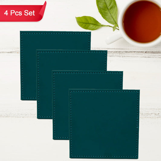 Stylish leather square coasters stacked, with one placed beside a small plant, enhancing home decor.