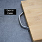 Thick cutting board made of bamboo, perfect for chopping vegetables.