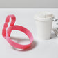 Lightweight tumbler handle attached to a mug, placed on a table for easy access.