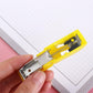 Closeup of compact colorful stapler with included staples